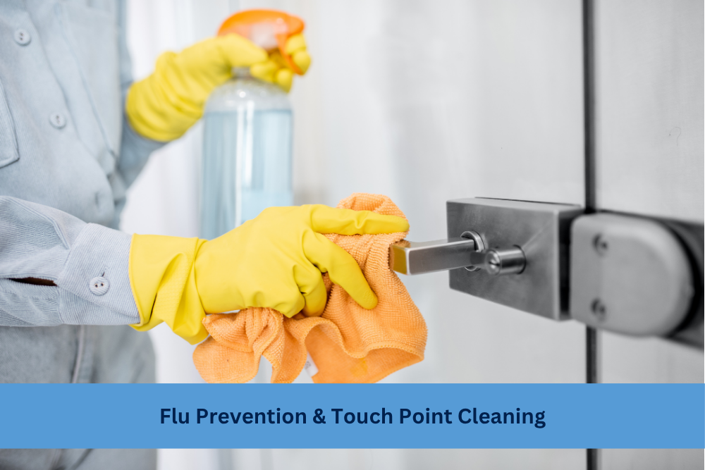 cleaner wearing yellow gloves with orange rag wiping door handle