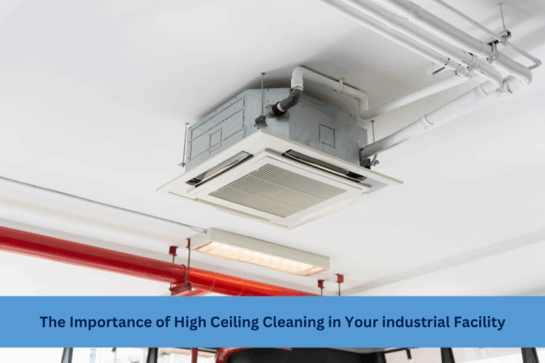 Industrial ceiling with HVAC unit, pipes, and sprinkler system highlighting the need for high ceiling cleaning in large facilities.